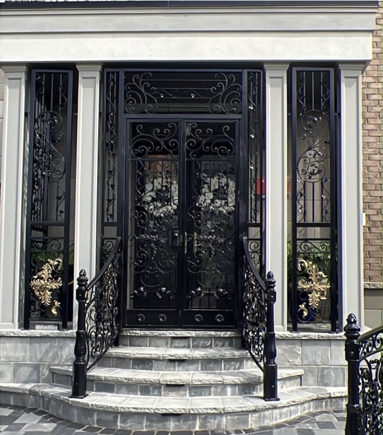 Wrought iron entrance doors, side panels and curved handrails with gold leaf details